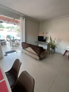 a living room with a couch in front of a window at Allmedhouse in São Luís