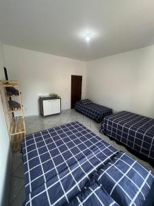 a room with two beds and a television in it at Allmedhouse in São Luís +23 photos