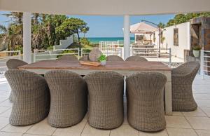a wooden table with wicker chairs on a patio at The Beach Palace Ramsgate in Margate
