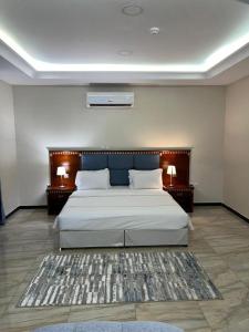 a bedroom with a large bed with two night stands at كاسا للشقق المخدومة 2 in Dammam +72 photos
