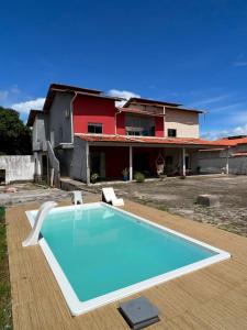 a swimming pool in front of a house at Allmedhouse in São Luís