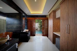 a bathroom with a sink and a bath tub at Lalasa Villas Canggu in Canggu