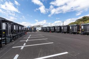 a row of train cars parked in a parking lot at HOTEL R9 The Yard Shintomi in Imabyū