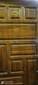 a wooden cabinet with a sign on top of it at Sakez Homestays HH in Hyderabad
