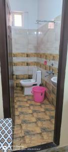 a bathroom with a toilet and a sink at Sakez Homestays HH in Hyderabad +7 photos
