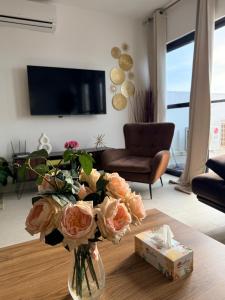 a vase of flowers on a table in a living room at Luxury & Comfort, with Pool and Ocean Views in Bijilo
