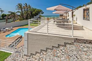 a villa with a swimming pool and a patio at The Beach Palace Ramsgate in Margate