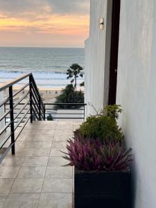 a balcony with a view of the beach at Luxury & Comfort, with Pool and Ocean Views in Bijilo