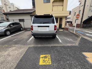 a white van parked in a parking lot with a sign at HoTTOSTAY矢田 in Nagoya