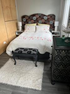 a bedroom with a bed and a table with a rug at Centrally located peaceful place in Greymouth