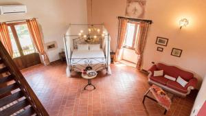 a bedroom with a bed and a couch at Hotel Lady Lusya in Syracuse