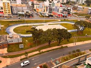 a city street with a white car on a road at Belissímo in Brasília +3 photos