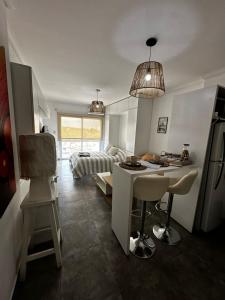 a room with a bed and a kitchen with a table at Vista Haus in General Sarmiento