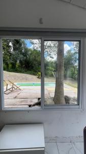 a window in a room with a view of a tree at Casa Quinta La Jaula in Isla Paracao