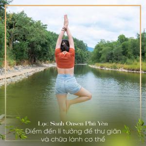 a woman doing a yoga pose in front of a river at Lạc Sanh Onsen Resort in Tuy Hoa +114 photos