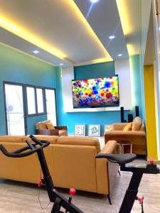 a living room with couches and a flat screen tv at Goat1 in Dakar