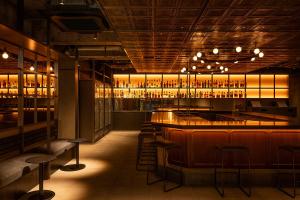 a bar with a lot of bottles of alcohol at THE KNOT FUKUOKA Tenjin in Fukuoka