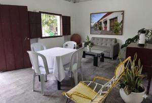 a living room with a white table and chairs at Casa Hotel Bijaos in Mompós