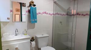a bathroom with a shower and a toilet and a sink at Chalé da Ana in Ouro Preto