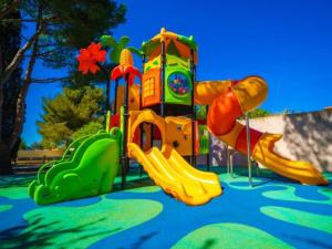 a childrens playground with a slide at Cottage avec clim - 4 pers. - API-1-52-2191 in Balaruc-les-Bains