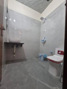 a bathroom with a sink and a toilet at Taj Street Hostel in Agra