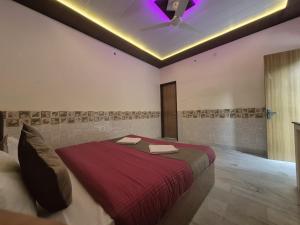 a bedroom with a large bed with a purple ceiling at Taj Street Hostel in Agra +117 photos