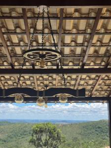a chandelier hanging from a ceiling with a view at Sítio com piscina em bh mirante do Sol in Santa Luzia