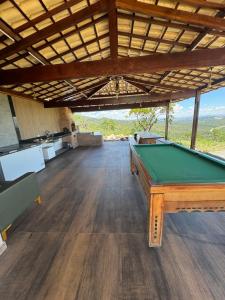 a pool table in a room with a view at Sítio com piscina em bh mirante do Sol in Santa Luzia