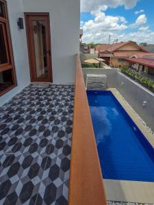 a house with a swimming pool and a tile floor at C Urban Villas 2 in Dau