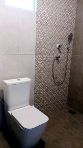 a bathroom with a toilet and a shower at Whisker & Waves, Panama in Panama