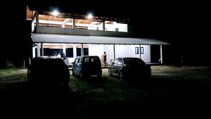 two cars parked in front of a building at night at Whisker & Waves, Panama in Panama
