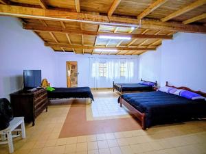 a living room with two beds and a flat screen tv at Departamento TERRA ANDRAY centro in Famatina