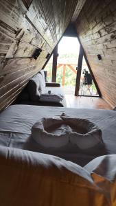 a room with a bed with a blanket on it at Cabana Janela do Céu in Jaboticatubas