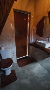 a bathroom with a shower and a toilet and a sink at Cabana Janela do Céu in Jaboticatubas +38 photos