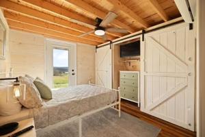 a bedroom with a bed and a barn door at Lake Cumberland Retreat in Faubush