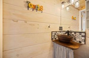 a bathroom with a sink and a wooden wall at Lake Cumberland Retreat in Faubush