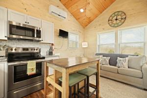 a kitchen and living room with a stove and a couch at Lake Cumberland Retreat in Faubush