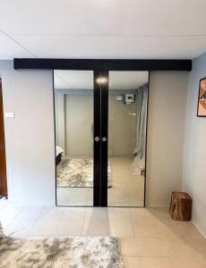 a room with a mirror and a room with a bedroom at Pridi cozy home with good location Type B in Bangkok