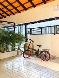 a bike is parked in a room with plants at Pridi cozy home with good location Type B in Bangkok
