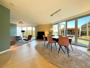 a living room with a dining table and chairs at Wellness Escape with Private Sauna in Sibculo