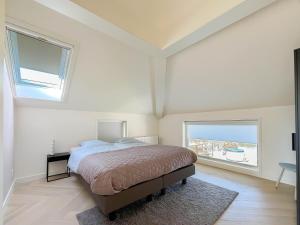 a white bedroom with a bed and two windows at Wellness Escape with Private Sauna in Sibculo +34 photos
