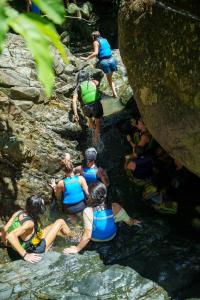 a group of people in the water on the rocks at Beach Hub 7 Mins to Airport in Carolina +5 photos