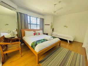 a bedroom with a large bed and a window at Residence71Nadi Fiji in Nadi +25 photos