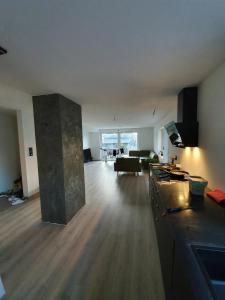 a living room with a couch and a table in a room at Aurora Central Premium Apartment II, Bodø in Bodø