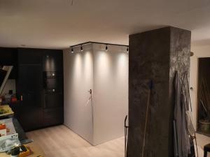 a room with a large white wall with lights on it at Aurora Central Premium Apartment II, Bodø in Bodø +9 photos