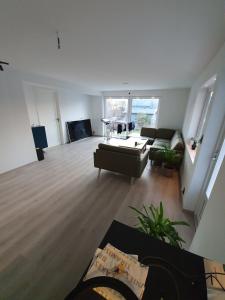 a living room with a couch and a table at Aurora Central Premium Apartment II, Bodø in Bodø