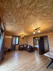a living room with a couch and a bed at Stillwood Tsikhisdziri in Kobuleti