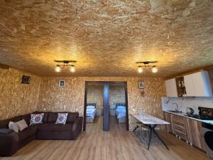 a living room with a couch and a table at Stillwood Tsikhisdziri in Kobuleti