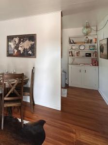 a room with a table and a dining room with a table and a cat at Pets Welcome Walkable Downtown Apt Gym & Pool Pass in Sheridan