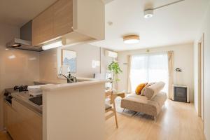 a kitchen and living room with a couch and a table at La Meridian Atsubetsu 401 in Sapporo